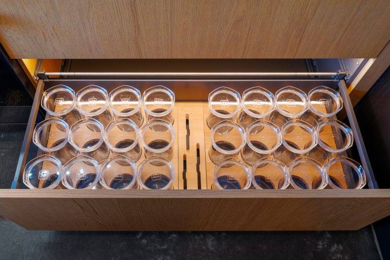 A specially crafted drawer holds glasses in the kitchen. Photo by Boaz Meri courtesy VRchitects.