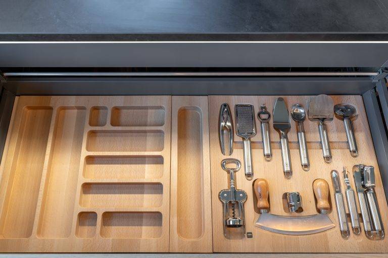 The kitchen is full of surprises. Many rollout drawers are custom fitted, so there’s a perfect spot to place tools, pots, spices and utensils. Photo by Boaz Meri courtesy VRchitects.