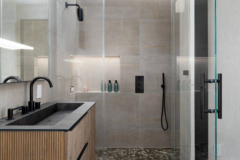 All the bathrooms feature tankless Axent toilets,epoxy resin sinks and curbless showers for easy access. Photo by Boaz Meri courtesy VRchitects.