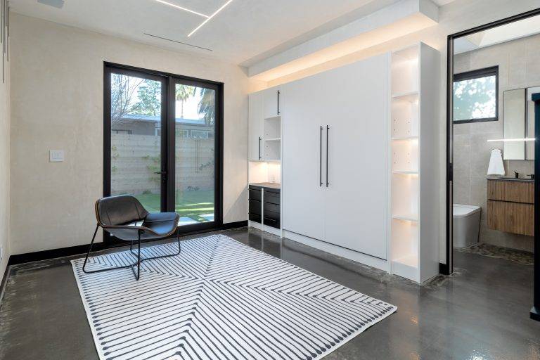 A Murphy bed is hidden against the wall in the downstairs game room, which doubles as a guest room. Photo by Boaz Meri courtesy VRchitects.